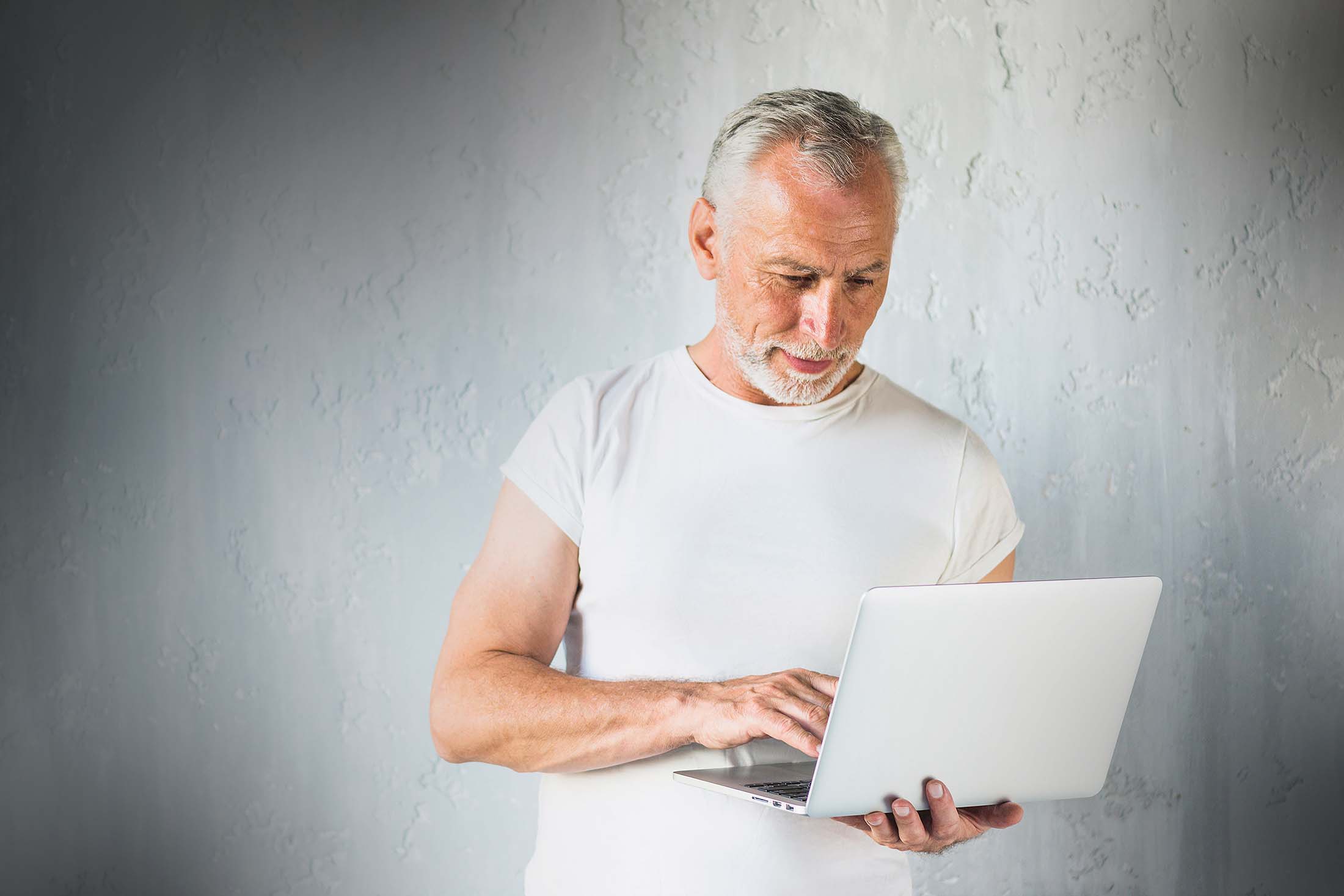 Elderly man on a computer looking for a web designer in spring tx area